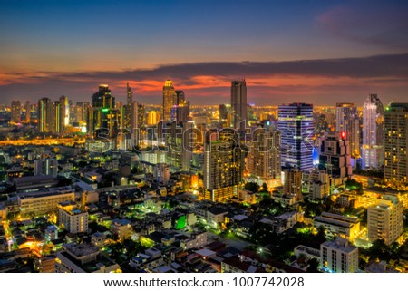 Sunset scence of modern office buildings and condominium in Bangkok city downtown with sunset sky and clouds at Bangkok , Thailand.