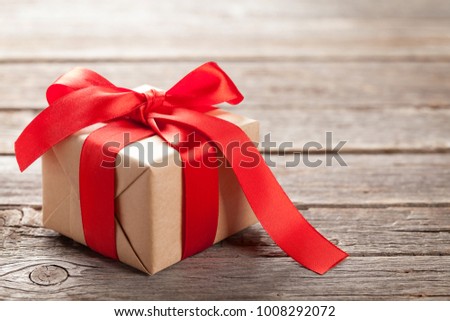 Valentines day gift box on wooden background. With space for your greetings