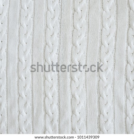 Background of white knitted jersey made of braid  