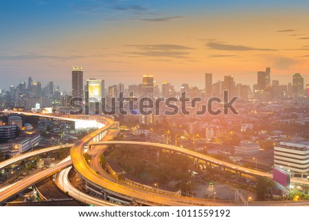 Bangkok city downtown over highway intersection with sunset sky cityscape background