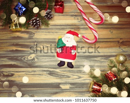 christmas background and decoration with fir branches garland lights on old wooden board copy space