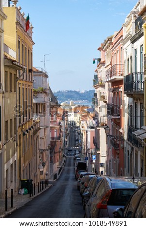 View down the street of Rua Sant Marcal with the Tagus river in the background. Lisbon, Portugal