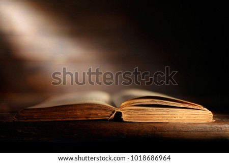 open book with a ray of light
