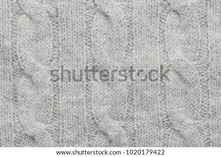 Grey kitted woolen fabric as a background
