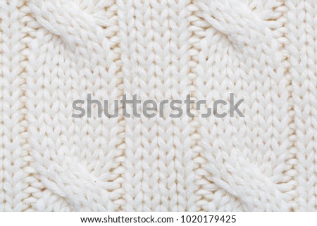 White/ecru knitted woolen fabric as a background