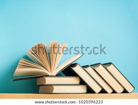 Open book on stack of books on wooden table. Education background. Back to school. Free copy space.