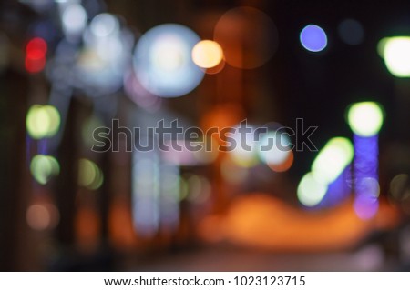 Night city street defocused lights background.
