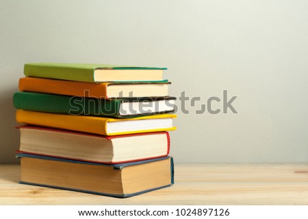 Stack of books on the wooden table. Education background.Back to school. Copy space for text.