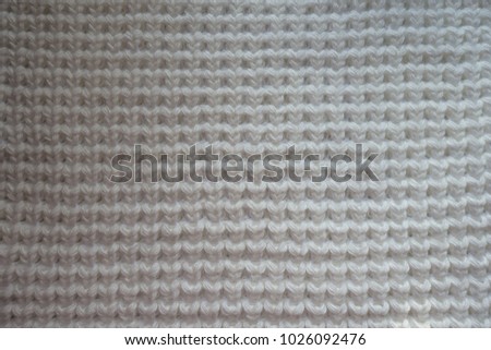 Ivory handmade knitted fabric texture from above