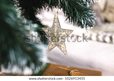 A star on a Christmas tree. New Year decoration. A Christmas decorative - star on the top of A Christmas tree with a beautiful bokeh background