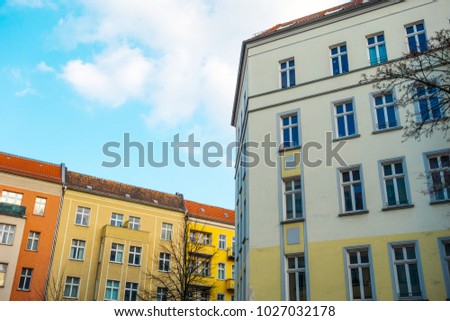 yellow houses in a street with copy space in the middle