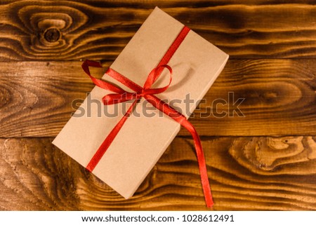 Cardboard gift box on rustic wooden table. Top view