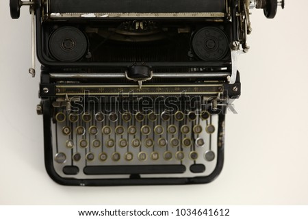 Antique typewriter against a crisp white backdrop.