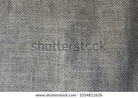 Texture of brown old canvas, linen natural material with a coarse perpendicular interlacing of the fibers of the fabric. The background.