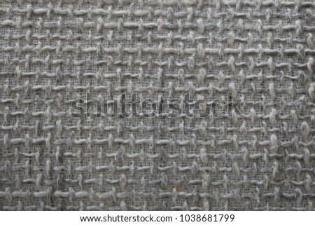 Closeup of a woven background in grey and white 