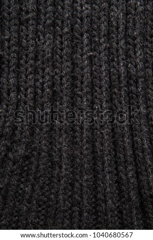 dark gray knitwear texture close up.