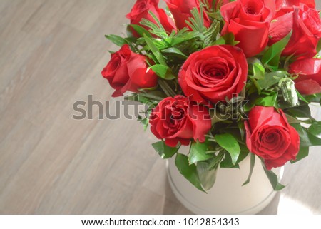 Close up of fresh red roses bouquet in a white round box  