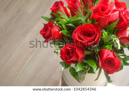 Close up of fresh red roses bouquet in a white round box  
