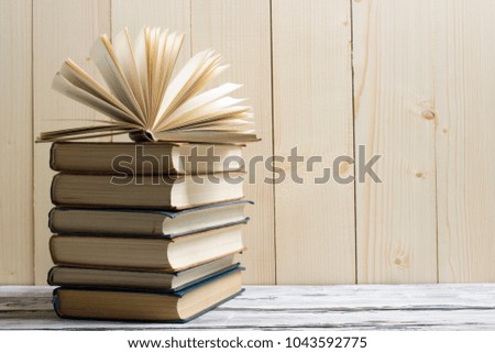 Open book, hardback books on wooden table. Back to school. Copy space