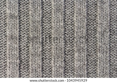 Knitting. Vertical striped gray knit fabric texture, knitted pattern background
