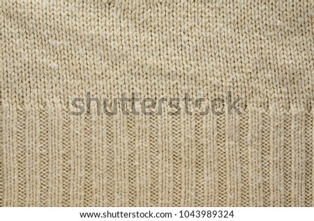 Beige Texture of a Knitted Sweater with Two Types of Knitting. Knit texture as background.