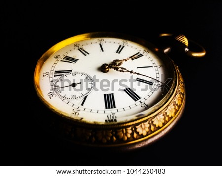 Beautiful close-up of an old watch isolated on a clipped black background - selective focus, time concept.
