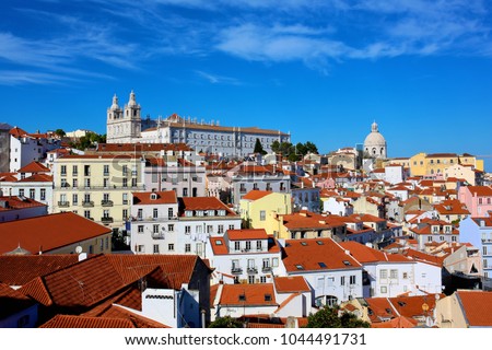 The magnificent view of Alfama district in Lisbon, Portugal, with traditional old yellow houses and red roofs.