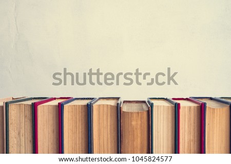 Old books on white wall background - Education concept, vintage tone