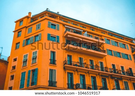 big mediterranean building with green windows