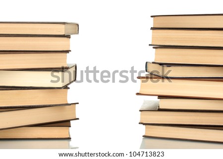 Two towers of books on white background close-up