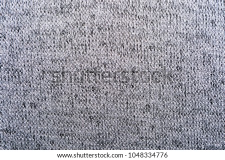 The texture of the knitted gray fabric for the background