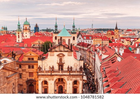 Landmark of Catholic Church stands tall above typical red roofs in Prague historical center , Prague, Czech Republic