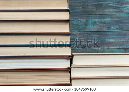 Stack books on wooden background. Back to school with copy space.