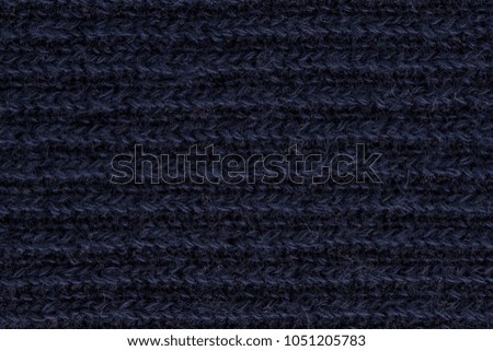 surface of dark navy knitted fabric.
