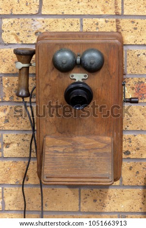 Antique telphone on brick wall