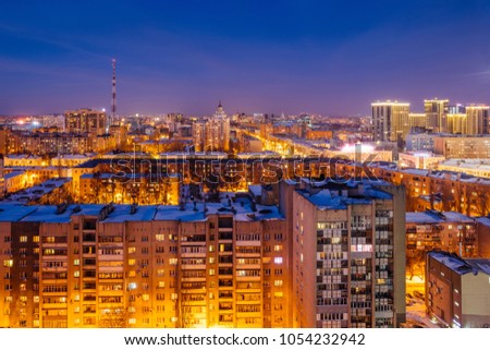 Aerial view of night Voronezh downtown. Voronezh cityscape at blue hour. Urban lights, modern houses, television tower