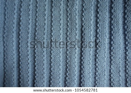 Wide ribs pattern on blue knitted fabric