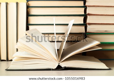 Open book and stack of books on wooden table. Education background. Back to school.