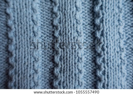 Vertical ribs pattern on blue knitted fabric