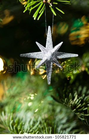 Decorative Silver Star ornament in a Christmas tree