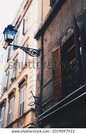 Beautiful lamp post and vintage old windows in Rome, Italy. Sunny day, shadows, amazing quite atmosphere of Trastevere district. 