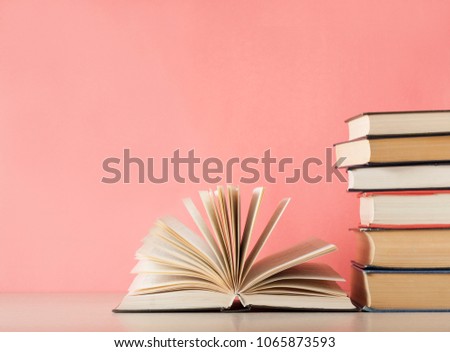 Open book and stack of books on wooden table. Education background. Back to school. Free copy space.