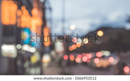 Abstract blur image of  Road and footpath in Night time with bokeh for background usage . (vintage tone)