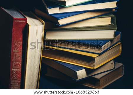 Tower Of Colorful Books On A Black Background. Concept Of Education And Knowledge