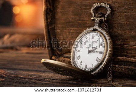 Old pocket watch on the wooden table with copy space 