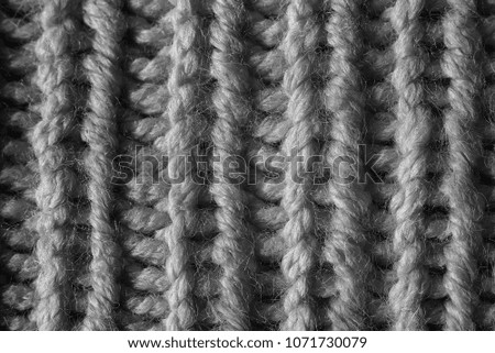 knitted pattern with knitting needles and purl loops black-and-white image