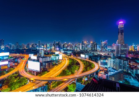 Cityscape and traffic at night in Bangkok, Thailand.
