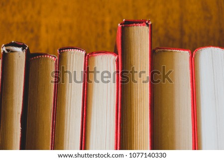 Row Of Red Old Books On The Wooden Background