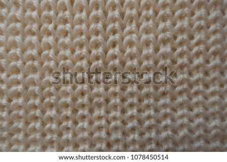 Vertical wales on beige knitted fabric from above