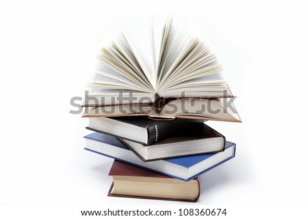 A stack of books on a white background. Open book.